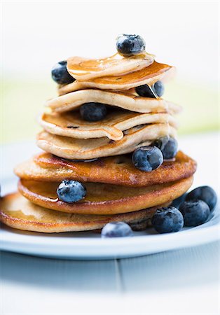 A Stack of Pancakes with Fresh Blueberries and a Syrup Stock Photo - Premium Royalty-Free, Code: 659-07598359