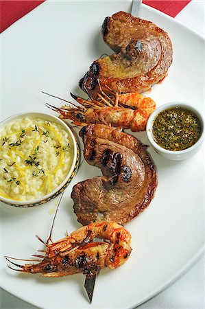A skewer of barbecued beef and prawns, with lemon risotto Stock Photo - Premium Royalty-Free, Code: 659-07598418