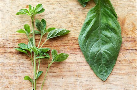 simsearch:659-06155419,k - A Fresh Sprig of Oregano next to a Leaf of Basil Stock Photo - Premium Royalty-Free, Code: 659-07598556