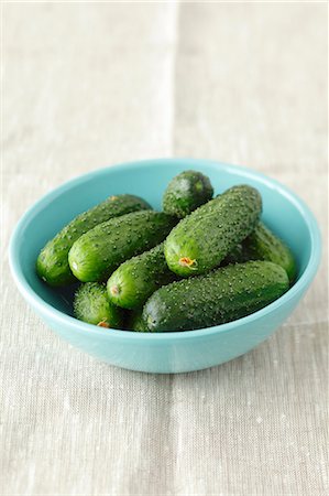 pickling gherkin - Several pickling cucumbers in a pale blue bowl Stock Photo - Premium Royalty-Free, Code: 659-07598579