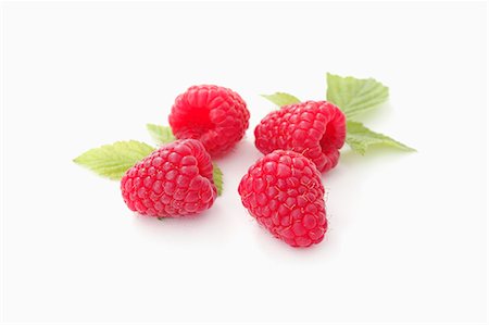 raspberry - Four raspberries with leaves Stock Photo - Premium Royalty-Free, Code: 659-07598661