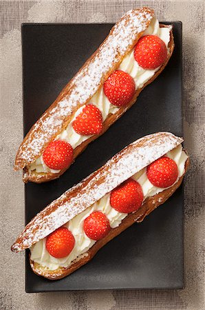 puff pastry sweet - Eclairs with cream and strawberries Stock Photo - Premium Royalty-Free, Code: 659-07598705