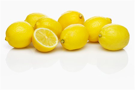 pictures of fruits - Several whole lemons and one half lemon Stock Photo - Premium Royalty-Free, Code: 659-07598815