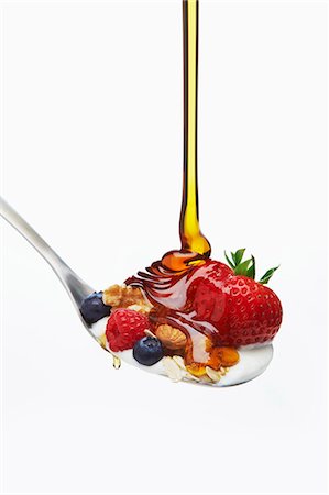 fruit muesli - Honey Flowing on a Spoon with Berry Muesli Stock Photo - Premium Royalty-Free, Code: 659-07599056