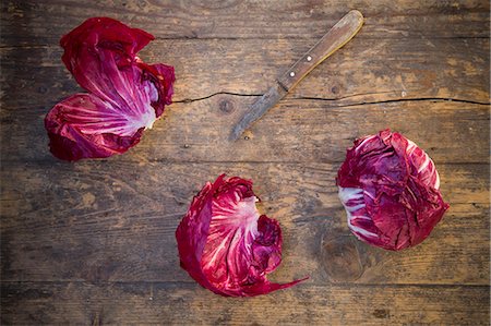Radicchio with a knife on a wooden table Stock Photo - Premium Royalty-Free, Code: 659-07599120
