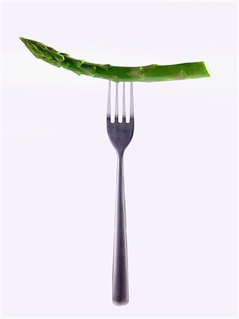 food photography - A stem of green asparagus on a fork Stock Photo - Premium Royalty-Free, Code: 659-07599294