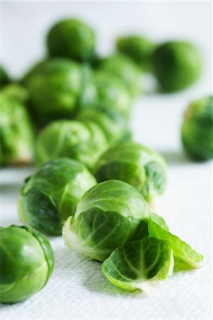 Brussels sprouts on a white surface Stock Photo - Premium Royalty-Free, Code: 659-07599379