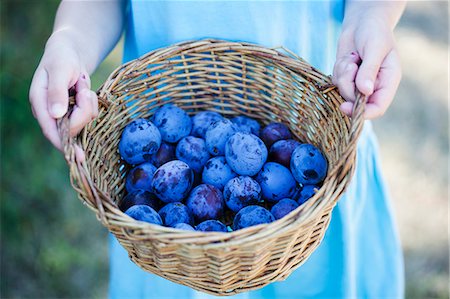 fresh fruits basket pictures - A girl holding a basket of plums Stock Photo - Premium Royalty-Free, Code: 659-07609735