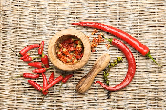 Chilli peppers in an olive wood mortar Stock Photo - Premium Royalty-Free, Image code: 659-07609942