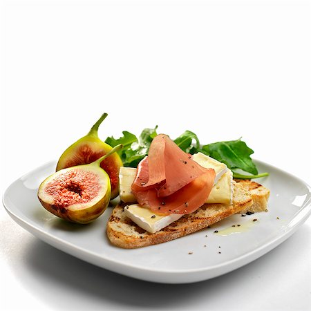 european cuisine - italian dry cured ham with brie cheese and figs Stock Photo - Premium Royalty-Free, Code: 659-07610002