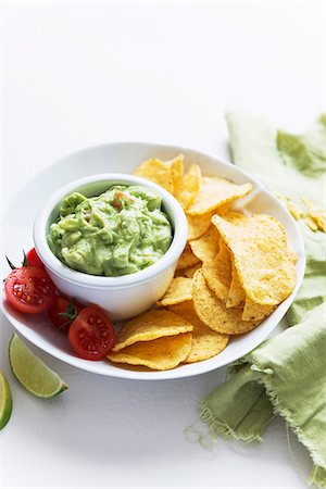 Guacamole, crisps and tomatoes Stock Photo - Premium Royalty-Free, Code: 659-07610070