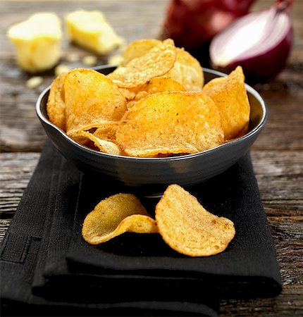 A bowl of cheese and onion crisps Stock Photo - Premium Royalty-Free, Code: 659-07610245