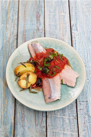 simsearch:659-06183827,k - Soused herring fillets with tomato sauce, olives and rosemary potatoes Photographie de stock - Premium Libres de Droits, Code: 659-07610297