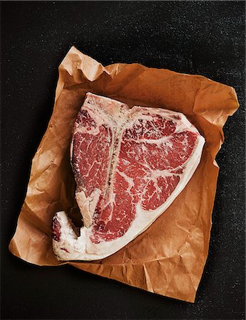 Porterhouse steak on a piece of paper Fotografie stock - Premium Royalty-Free, Codice: 659-07738655