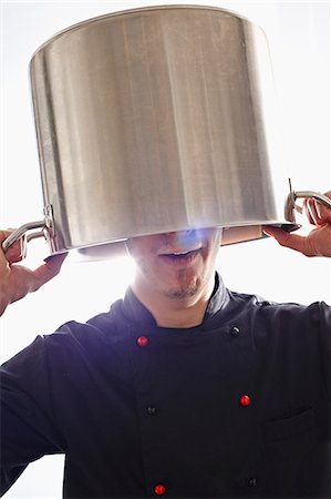 A chef holding a pot over his head Stock Photo - Premium Royalty-Free, Code: 659-07738826