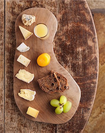 A cheese board with bread and grapes (seen from above) Stock Photo - Premium Royalty-Free, Code: 659-07739190