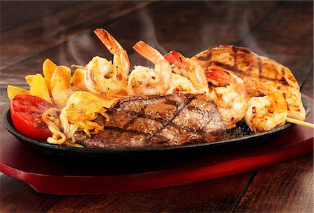 shrimp kebab - Surf and Turf with tomatoes and chips Stock Photo - Premium Royalty-Free, Code: 659-07739478