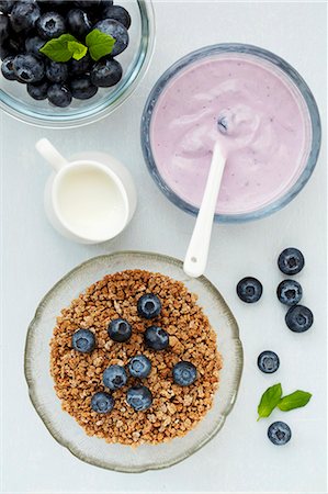 Bowls of crunchy breakfast cereal, fresh blueberries and blueberry yoghurt Photographie de stock - Premium Libres de Droits, Code: 659-07739471