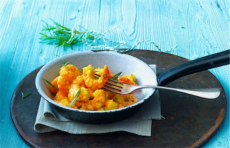 shrimp in frying pan dish - Prawns with curry and rosemary in a pan Stock Photo - Premium Royalty-Free, Code: 659-07739538