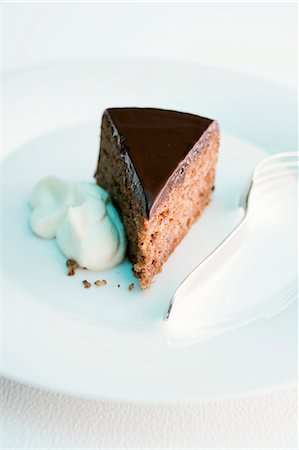 piece of chocolate cake - A Slice of Triple Layer Chocolate Cake Stock Photo - Premium Royalty-Free, Code: 659-07739571