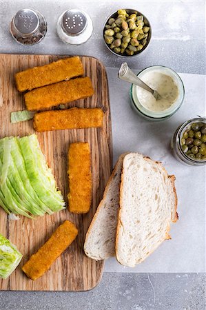 fish sticks - A fish finger sandwich with tartare sauce and capers being made Stock Photo - Premium Royalty-Free, Code: 659-07958825