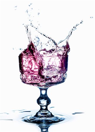 A purple drink splashing from a glass Stock Photo - Premium Royalty-Free, Code: 659-07958903