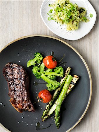 salad accompaniment - Beef steak with grilled asparagus and potato salad Stock Photo - Premium Royalty-Free, Code: 659-07958999