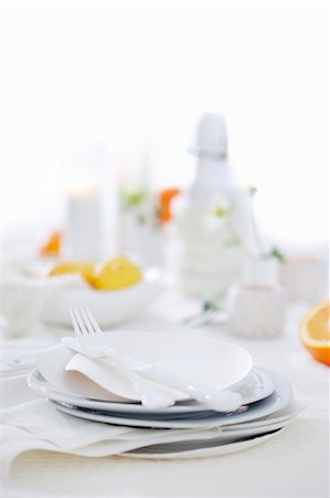 A table laid with white plates and cutlery Stock Photo - Premium Royalty-Free, Code: 659-07959075