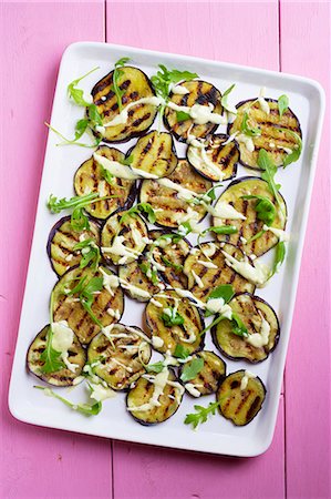 simsearch:659-06307235,k - Grilled aubergine slices with tahini and a yoghurt dressing Stock Photo - Premium Royalty-Free, Code: 659-07959291