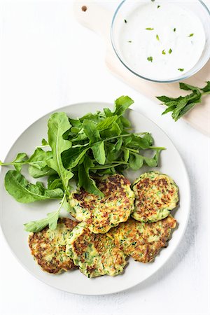 Courgette cakes with a rocket salad Stock Photo - Premium Royalty-Free, Code: 659-07959370
