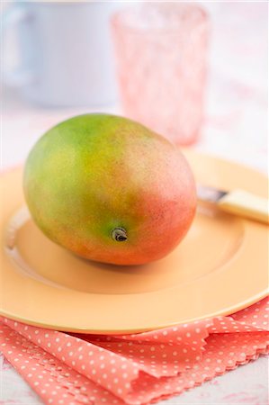 simsearch:659-02213540,k - A fresh mango on a plate Stock Photo - Premium Royalty-Free, Code: 659-07959620