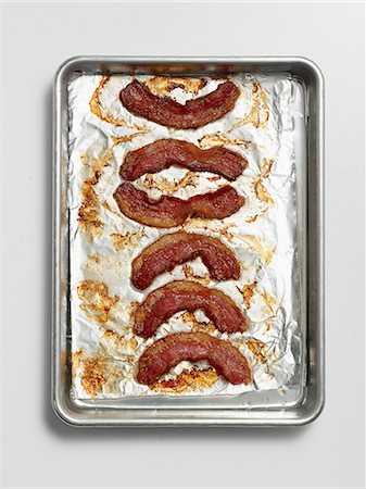 simsearch:659-06154402,k - Roasted rashers of bacon on a baking tray lined with tin foil Stock Photo - Premium Royalty-Free, Code: 659-07959715