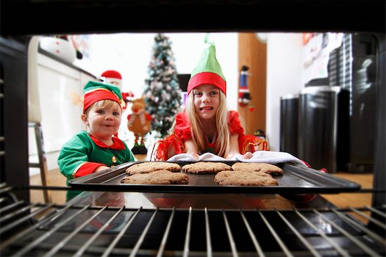 Two children baking Christmas biscuits Stock Photo - Premium Royalty-Free, Image code: 659-07959833