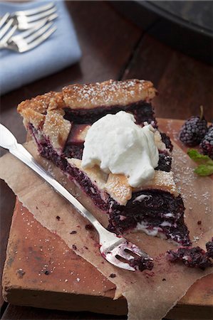A slice of mulberry pie with cream with a bite taken out Stock Photo - Premium Royalty-Free, Code: 659-08147067