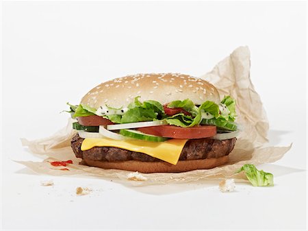 A cheeseburger on a piece of paper Stock Photo - Premium Royalty-Free, Code: 659-08147093