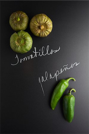 peperoncini - Tomatillos and jalapeños on a slate surface with labels Stock Photo - Premium Royalty-Free, Code: 659-08147218
