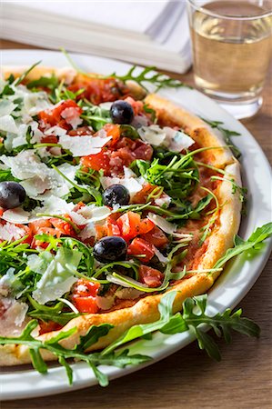 Pizza bruschetta with olives, cheese, rocket and tomato Photographie de stock - Premium Libres de Droits, Code: 659-08147288