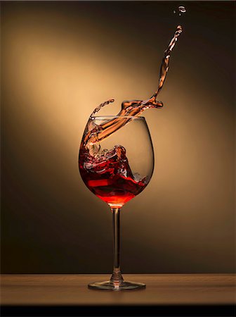 splashing drink in glass - Red wine splashing out of a glass Stock Photo - Premium Royalty-Free, Code: 659-08147283