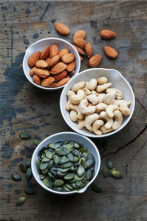 seeds and nuts - Bowls of almonds, cashew nuts and pumpkin seeds Stock Photo - Premium Royalty-Free, Code: 659-08147431