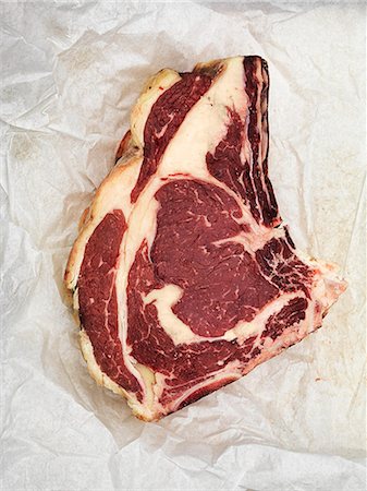 steak on paper - Raw beef steak on paper Stock Photo - Premium Royalty-Free, Code: 659-08147444