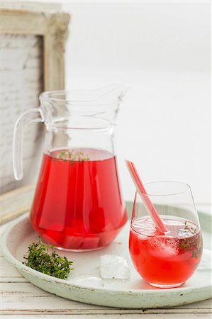 Rhubarb iced tea in a glass and a jug Stock Photo - Premium Royalty-Free, Code: 659-08147532