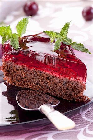 A slice of chocolate cake with cherries and jelly Stock Photo - Premium Royalty-Free, Code: 659-08147585