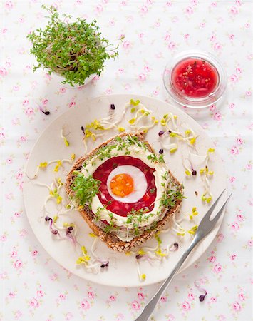 sunny side up - A slice of wholemeal bread topped with beetroot aspic, egg, mayonnaise, cress and radish sprouts Stock Photo - Premium Royalty-Free, Code: 659-08148084