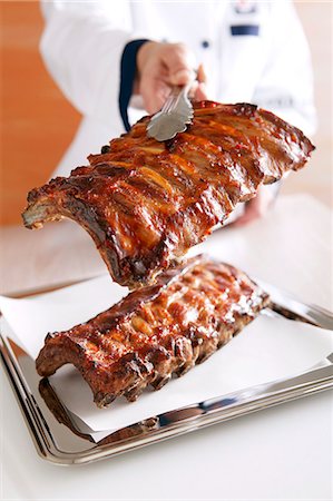 pork dish - A chef holding grilled spare ribs with tongs Stock Photo - Premium Royalty-Free, Code: 659-08148156