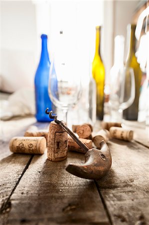 A corkscrew, corks, empty wine bottles and glasses Stock Photo - Premium Royalty-Free, Code: 659-08418701