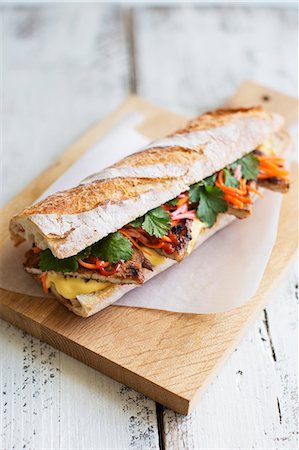 simsearch:659-08905205,k - Banh Mi sandwich with pork, coriander, pickled carrots radishes and mayonnaise (Vietnam) Photographie de stock - Premium Libres de Droits, Code: 659-08418752