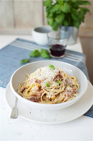 simsearch:659-01866087,k - Spaghetti carbonara with fresh basil and Parmesan cheese Stock Photo - Premium Royalty-Free, Code: 659-08418764