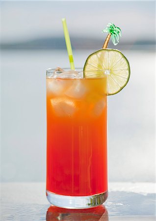 summer drink nobody - A Mai Tai cocktail on a table by a lake Stock Photo - Premium Royalty-Free, Code: 659-08418840