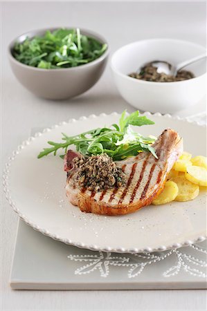 pork cutlet - A grilled chop with potato and rocket salad Stock Photo - Premium Royalty-Free, Code: 659-08418915