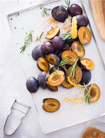 Damsons with rosemary, lemon zest and sugar on a baking tray Stock Photo - Premium Royalty-Free, Code: 659-08419023